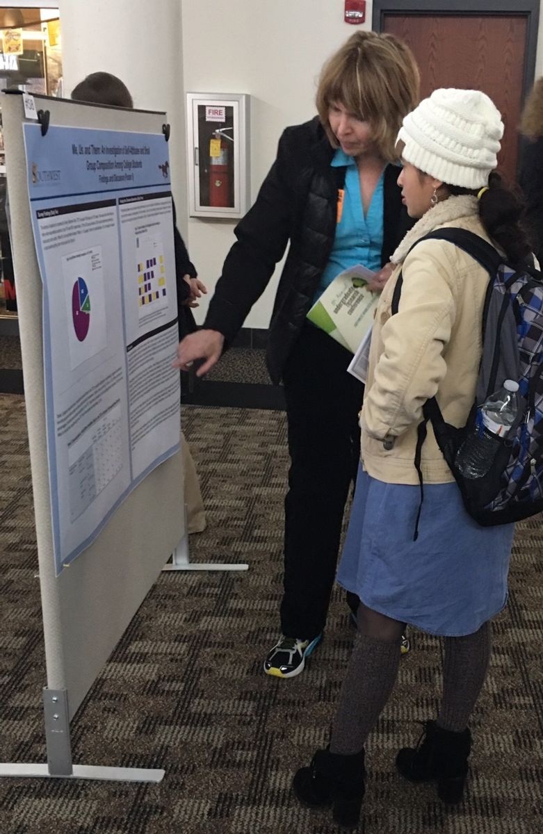Sociology student with poster at the URC